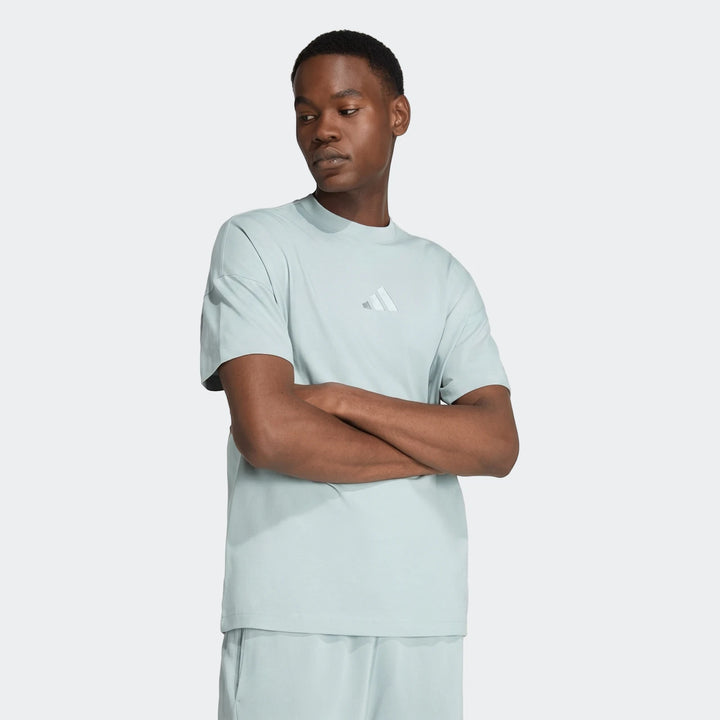 Light blue Adidas All Season T-Shirt on a male model, styled with matching shorts in a studio setting.