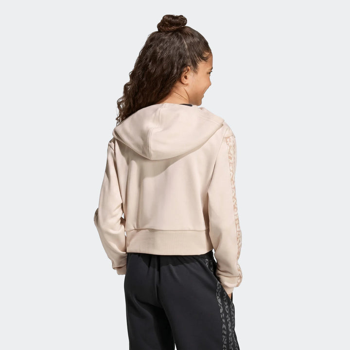 Young person in an Angled 3-Stripes French Terry Full-Zip Hoodie, light beige with patterned sleeves, seen from the back.