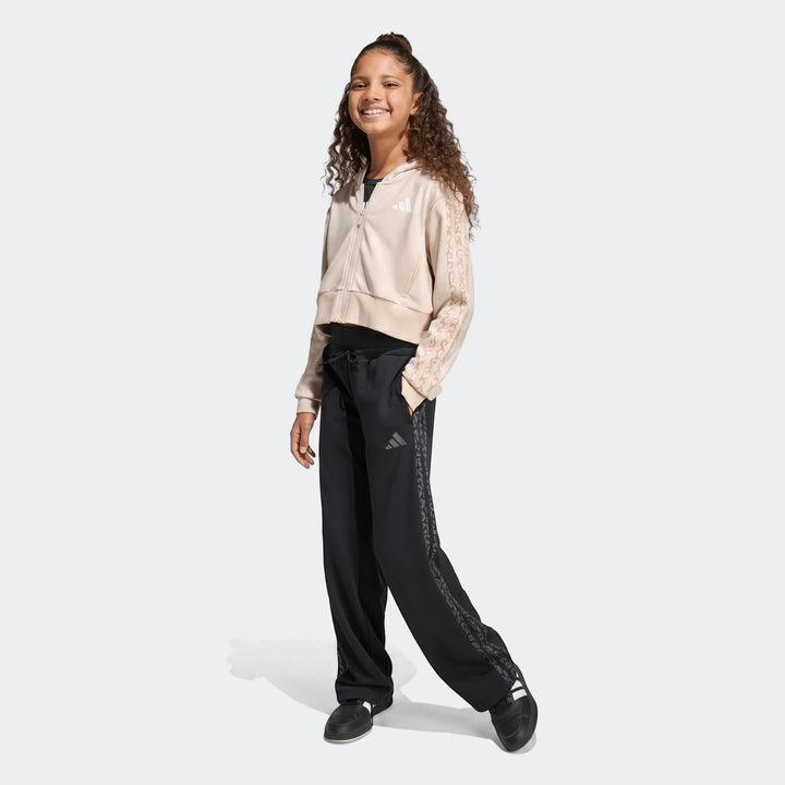 Young girl wearing an Angled 3-Stripes French Terry Full-Zip Hoodie in beige and black wide-leg track pants.