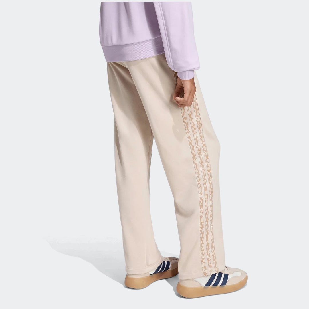Angled 3-Stripes French Terry Pants in beige, worn by a person from the side, showcasing the patterned 3-stripes detail