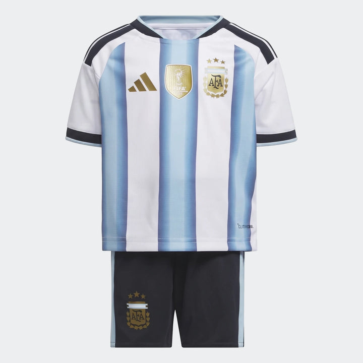 Argentina 26 Home Kids Set with a white and light blue striped jersey and black shorts, displayed as a flat lay from the