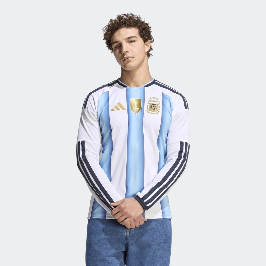 Male model wearing the official Argentina 26 Home Long Sleeve Jersey, showcasing its white and light blue striped design,
