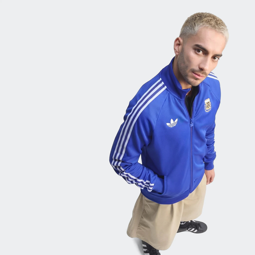 Argentina Originals Track Top for men in blue with white stripes and team crest, modeled from the chest up.