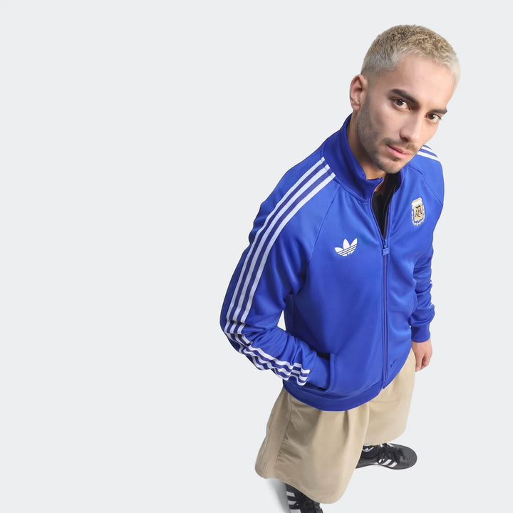 Argentina Originals Track Top for men in blue with white stripes and team crest, modeled from the chest up.