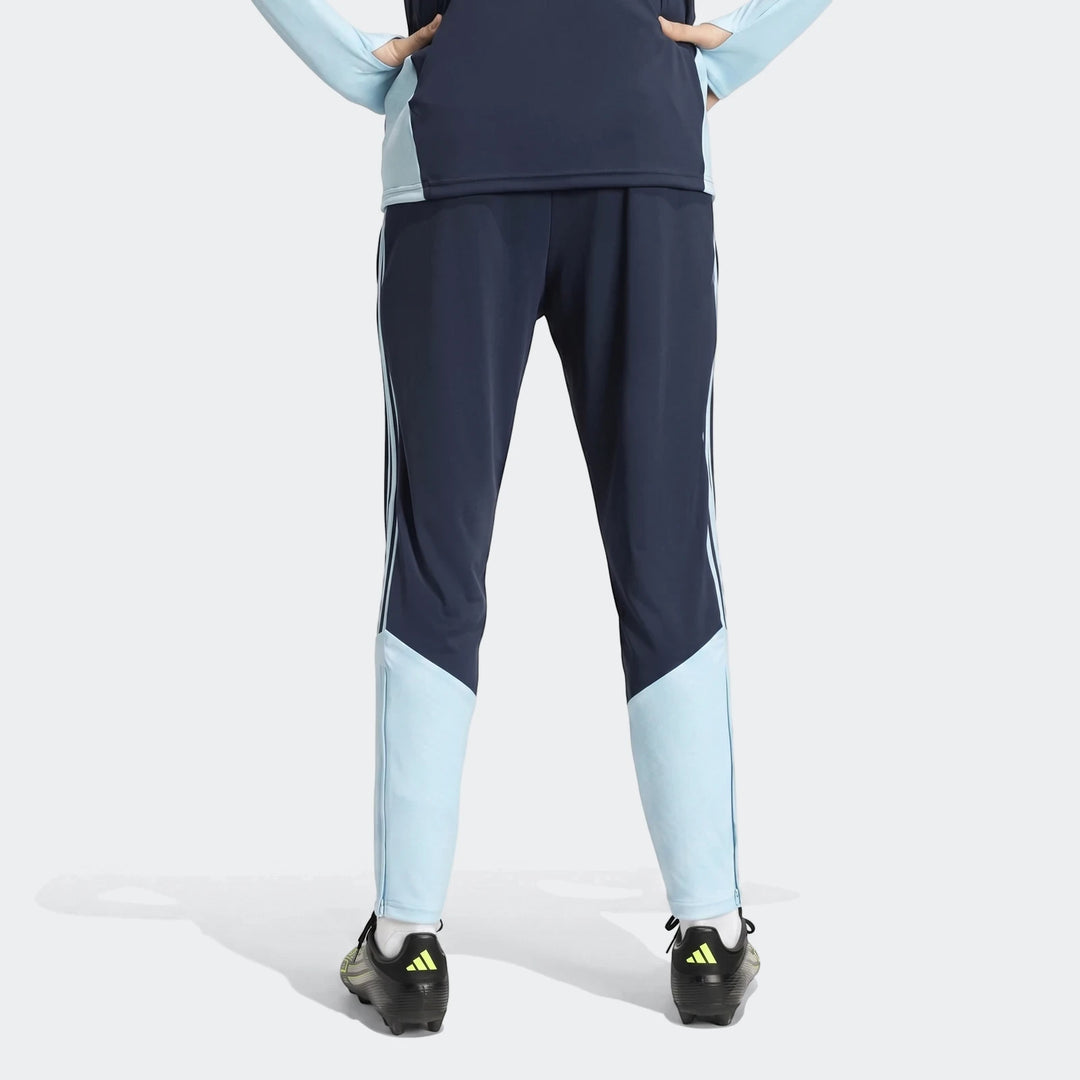 Navy blue and light blue Argentina Training Pants, shown from the back on a person wearing black and neon Adidas cleats.