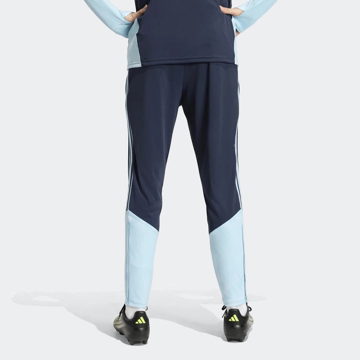 Navy blue and light blue Argentina Training Pants, shown from the back on a person wearing black and neon Adidas cleats.