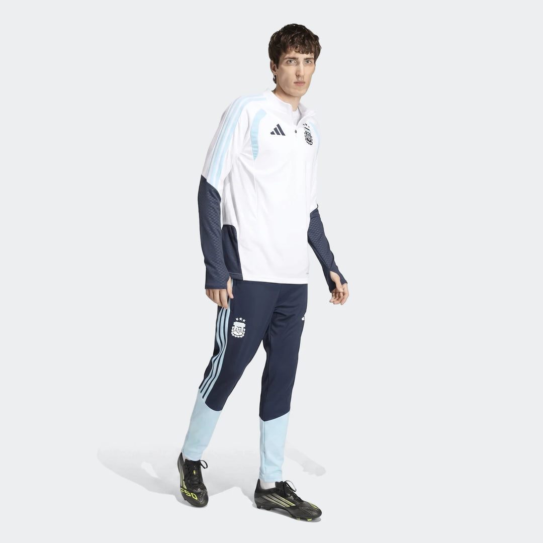 Male model wearing an official Adidas Argentina Training Top in white with light blue and navy accents, paired with matching