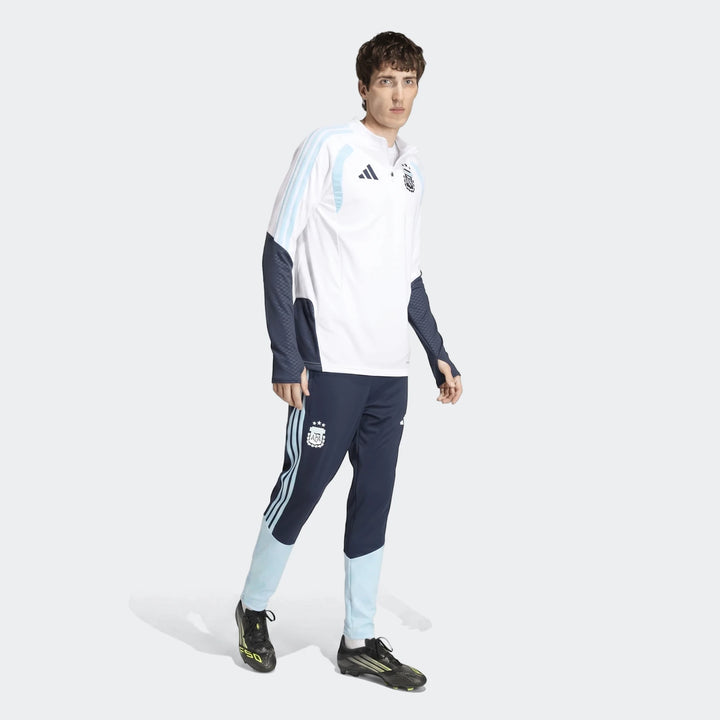 Male model wearing an official Adidas Argentina Training Top in white with light blue and navy accents, paired with matching