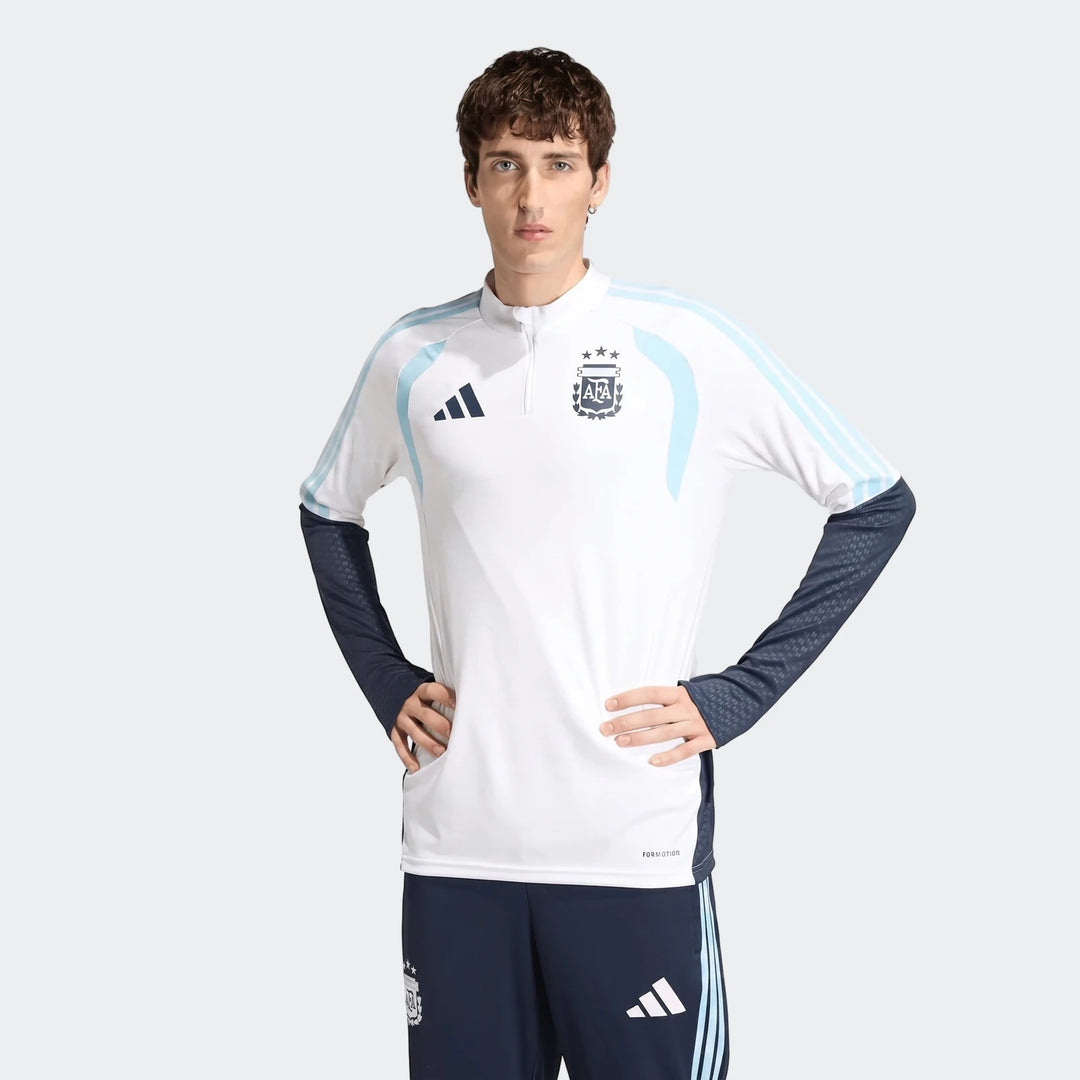 White and navy blue long-sleeve Argentina Training Top for men, featuring club crest and Adidas logo, worn by a model.