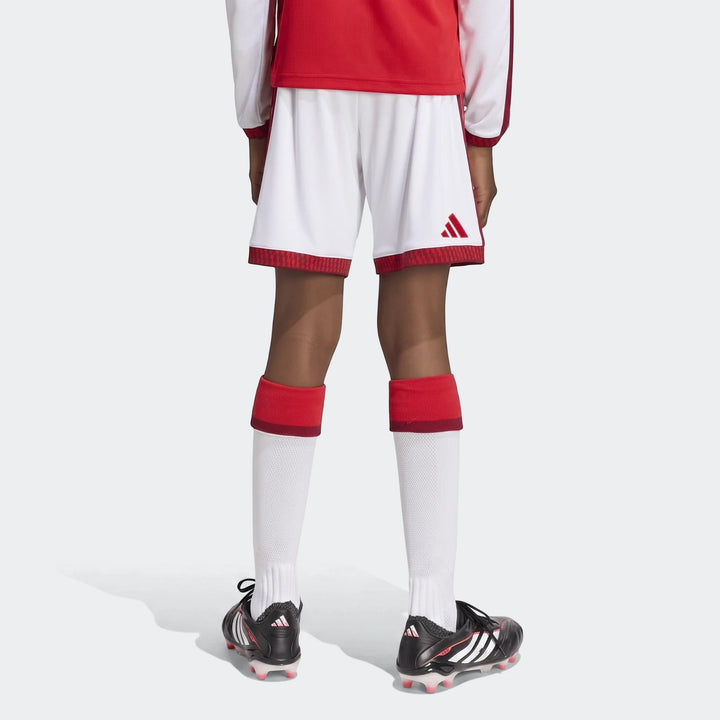 Youth Arsenal Fc 26/27 Home soccer shorts in white and red, worn with matching socks and cleats, shown from a back view.