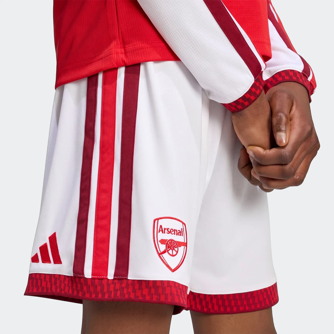 Arsenal Fc 26/27 Home Kids Shorts in white with red and maroon stripes, featuring the Arsenal crest and Adidas logo, worn by