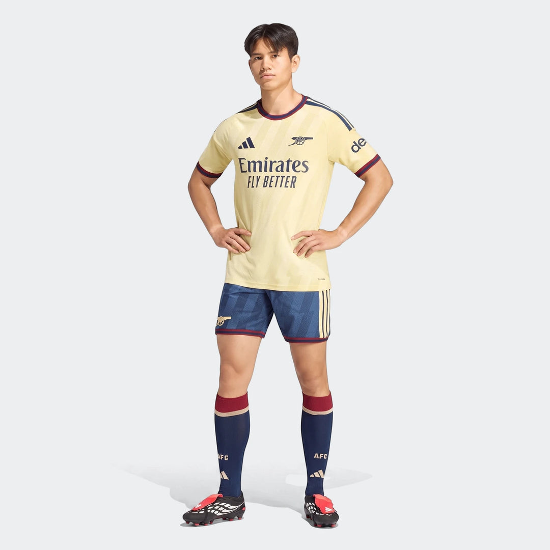 Male model wearing the Adidas Arsenal FC 26/27 Third Authentic Jersey in pale yellow with navy and maroon accents, navy