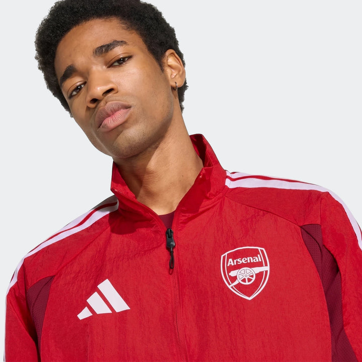 Arsenal FC Home Anthem Jacket in red with full zip front, white shoulder stripes, and Arsenal crest logo.