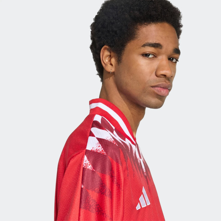 Arsenal FC Street Jersey in red with white striped collar and graphic print, shown in side profile.