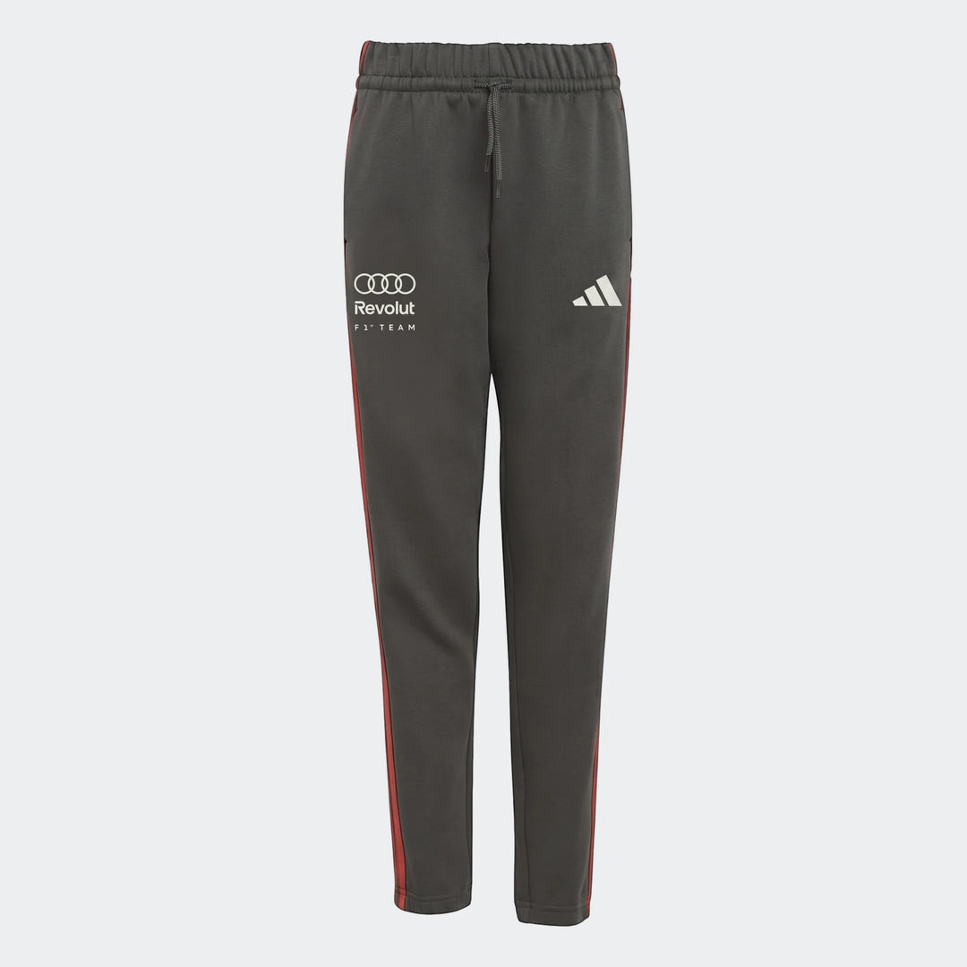 Audi Revolut F1 Team Dna Pants Youth in dark grey with red stripes, featuring Audi, Revolut, and Adidas branding.