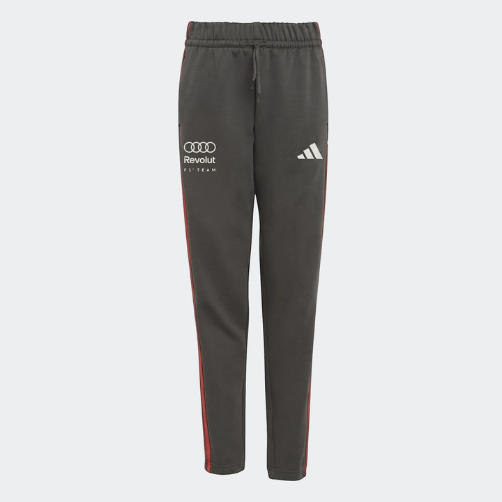 Audi Revolut F1 Team Dna Pants Youth in dark grey with red stripes, featuring Audi, Revolut, and Adidas branding.