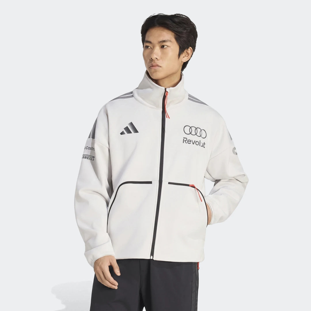 Male model wearing an off-white Audi Revolut F1 Team Engineers & Marketing Track Top jacket with Adidas, Castrol, and