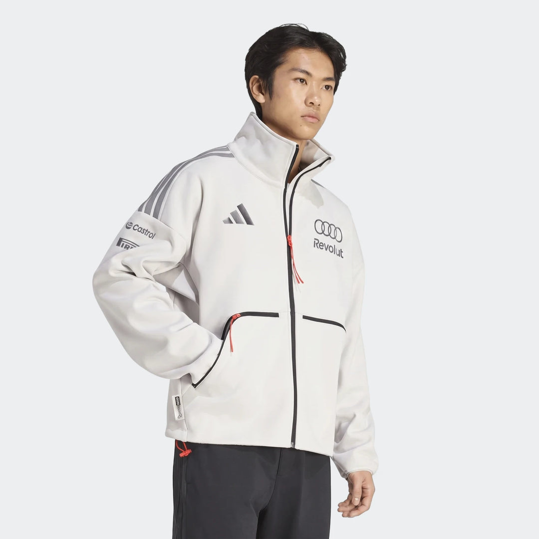 White Audi Revolut F1 Team Engineers & Marketing track top for men, featuring Adidas, Castrol, and Pirelli logos. Model view.