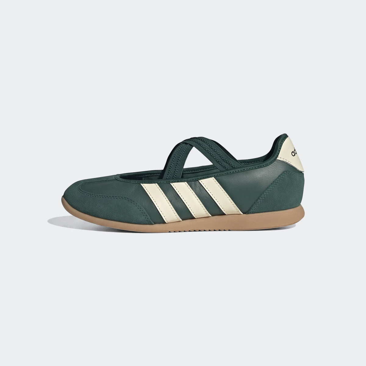 Dark green Adidas Barreda Mary Jane shoes with cream stripes and gum sole, side view.