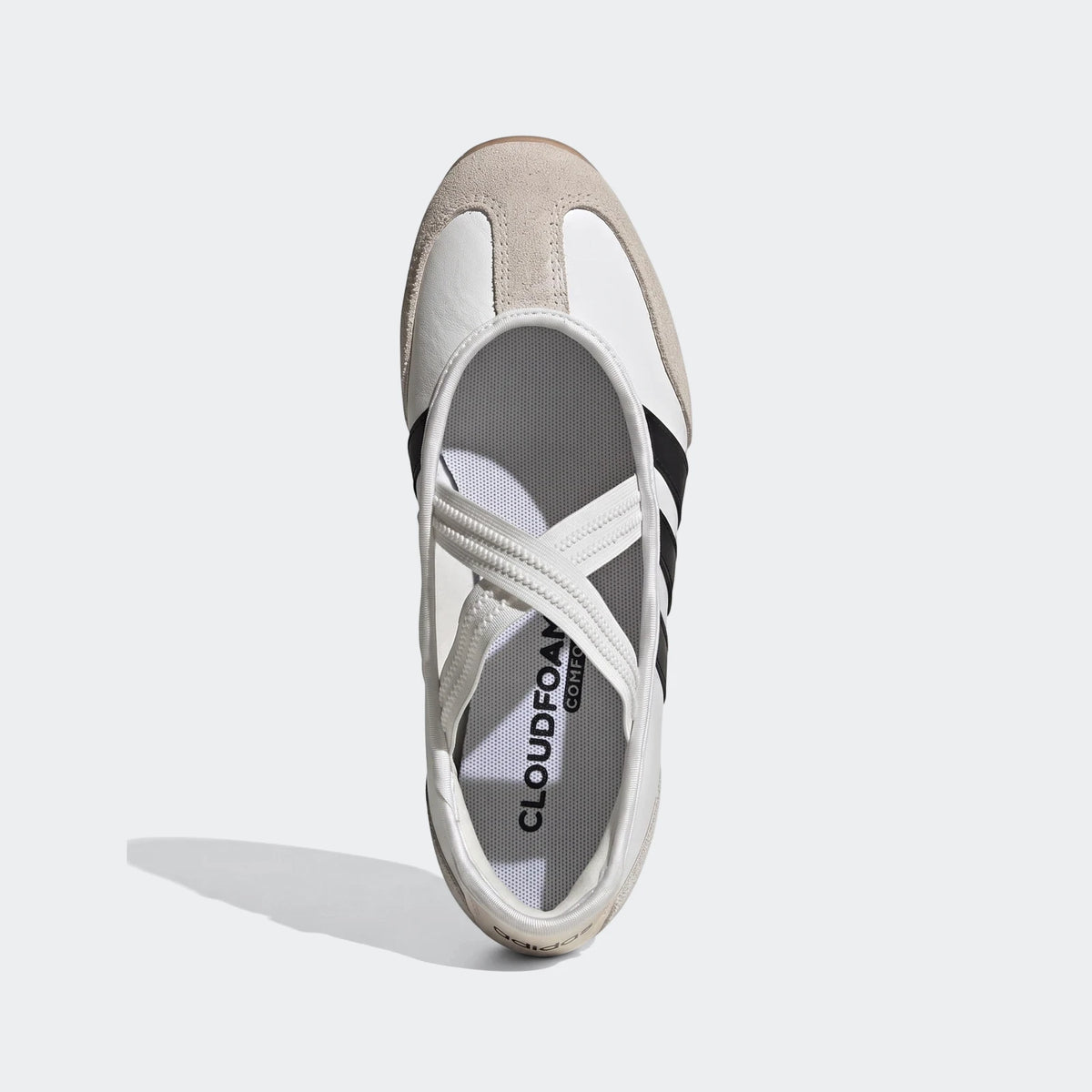 White Adidas Barreda Mary Jane shoes with black stripes and elastic cross straps, shown from an overhead flat-lay view.