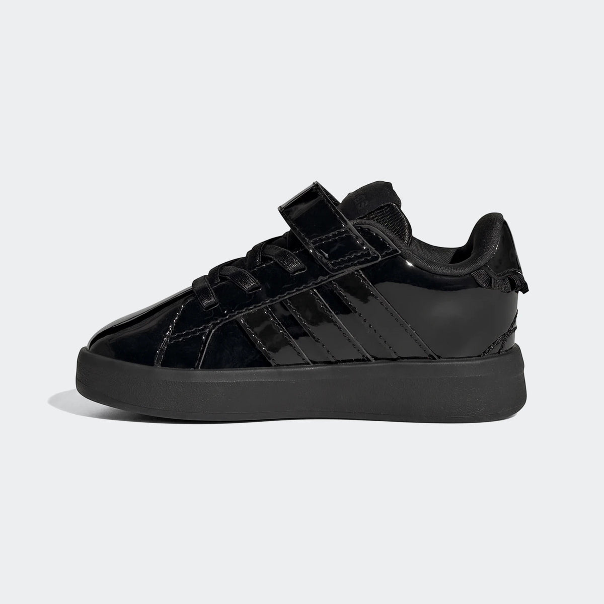 Black Adidas Grand Court 3.0 infant girl's shoes with glossy finish and hook-and-loop strap, side view.
