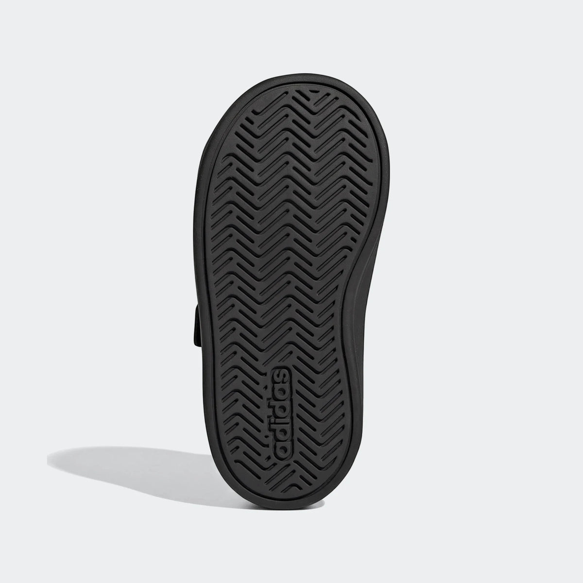 Black Adidas Grand Court 3.0 infant shoe, bottom sole view showing the chevron tread pattern and Adidas logo.