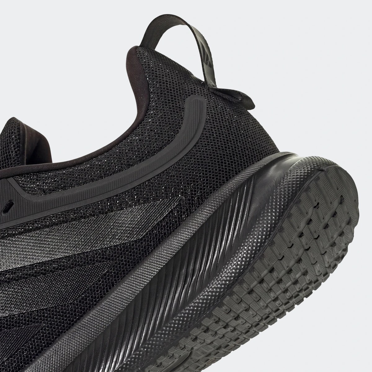 Black Adidas Runblaze W running shoe, showing the textured heel, midsole, and lugged outsole from an angled view.