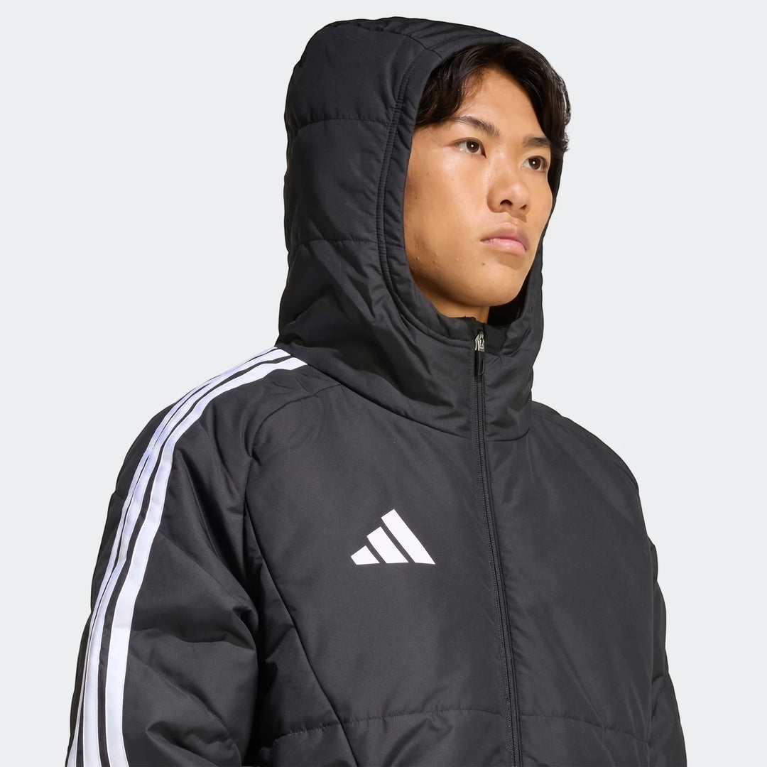 Close-up of a male model wearing a black Adidas Tiro 26 Windbreaker Jacket with a hood and white stripes on the arm.