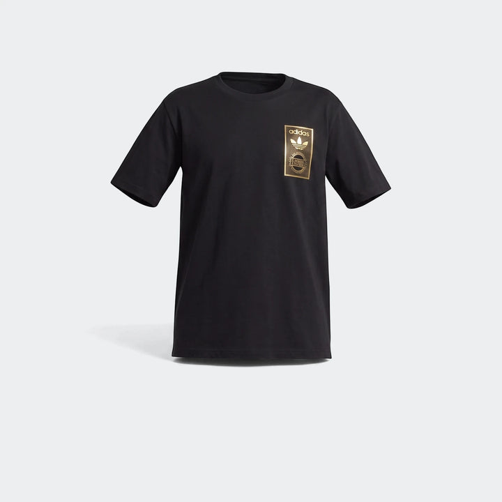 Black Adidas Varsity Gold T-shirt, front view. Features a metallic gold rectangular logo patch with the trefoil graphic on