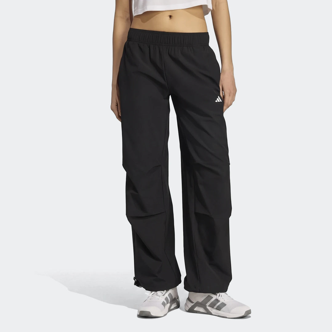 Black Adidas Workout Essentials Woven Training Joggers worn by a model, featuring an elastic waist and full-length design.