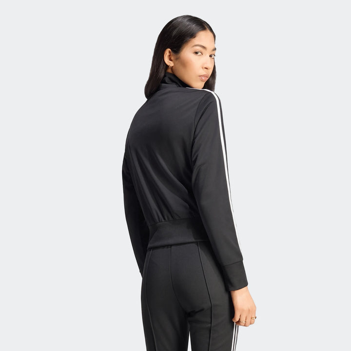 Black Firebird Classic Track Jacket with iconic white stripes on sleeves, paired with matching pants, worn by a female model