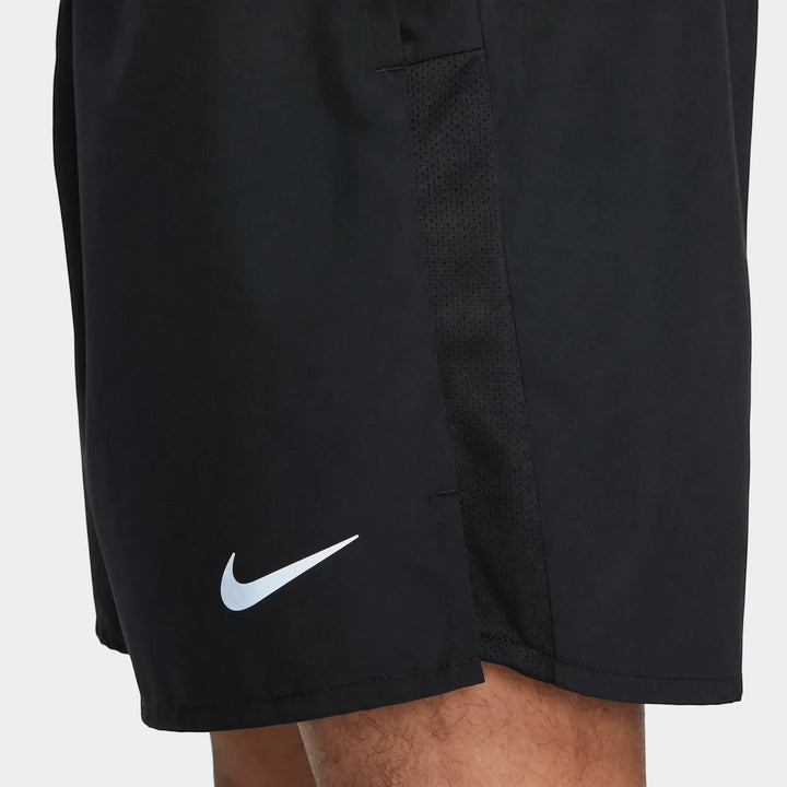 Black Nike Challenger Men's Dri-Fit Unlined Running Shorts featuring a white Nike swoosh logo and mesh side panel, worn by a