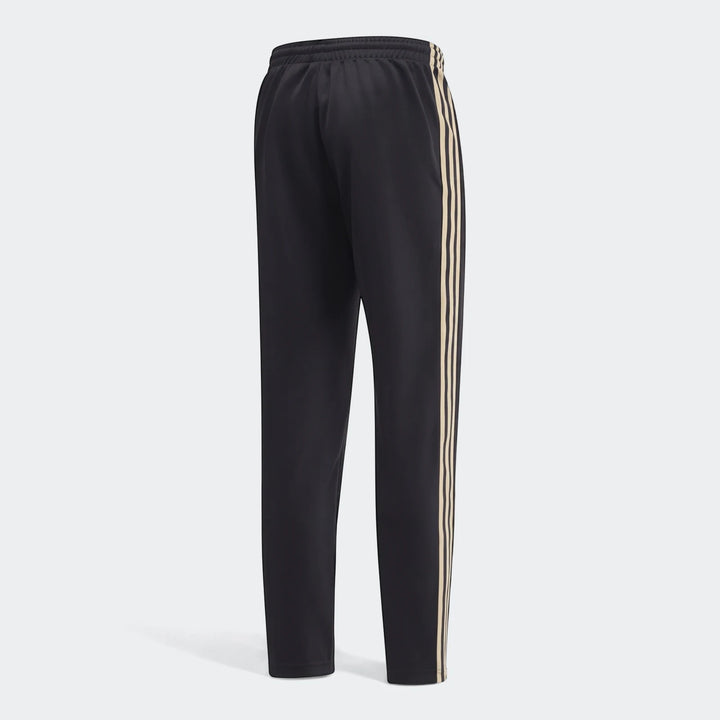 Black Op Og2 track pants with beige side stripes, shown from a back view, on a white background.