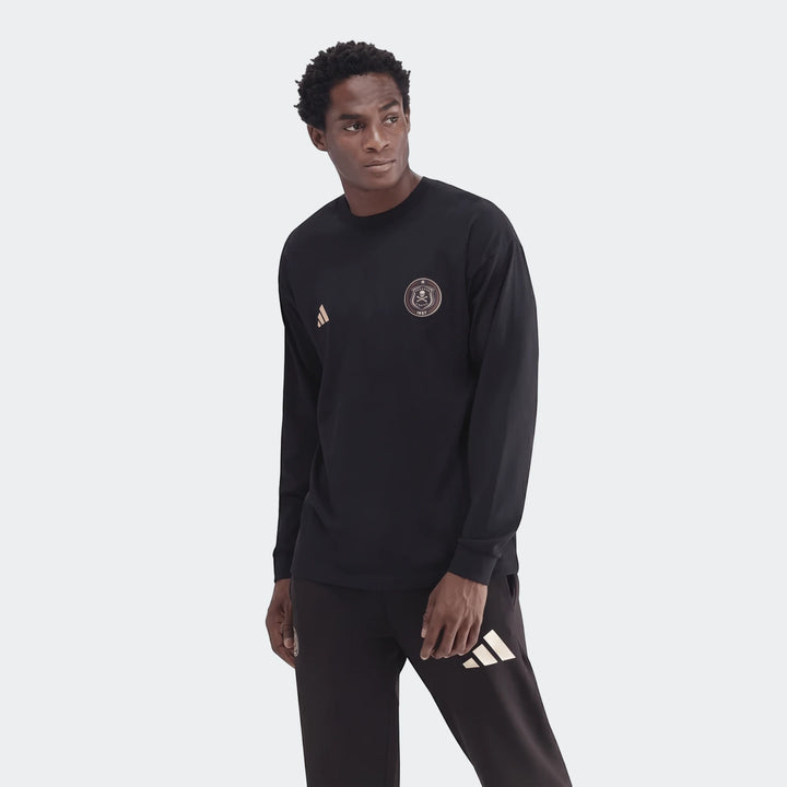 A man models a black Sportswear Open Hem Essentials+ Slim Long Sleeve T-Shirt with an Adidas logo and team crest.
