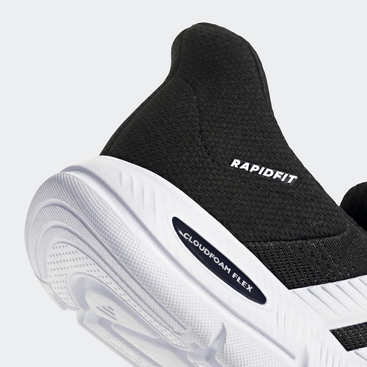 Close-up view of a black and white Adidas sneaker, featuring "RAPIDFIT" text on the mesh upper and "CLOUDFOAM FLEX" on the
