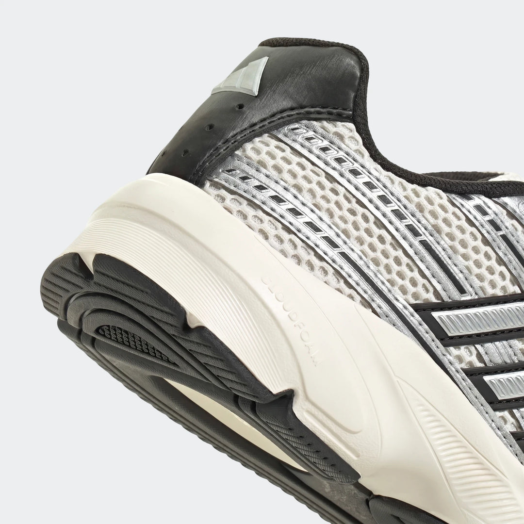 Close-up of the heel and sole of a black, white, and silver athletic sneaker, featuring mesh details and a Cloudfoam midsole.
