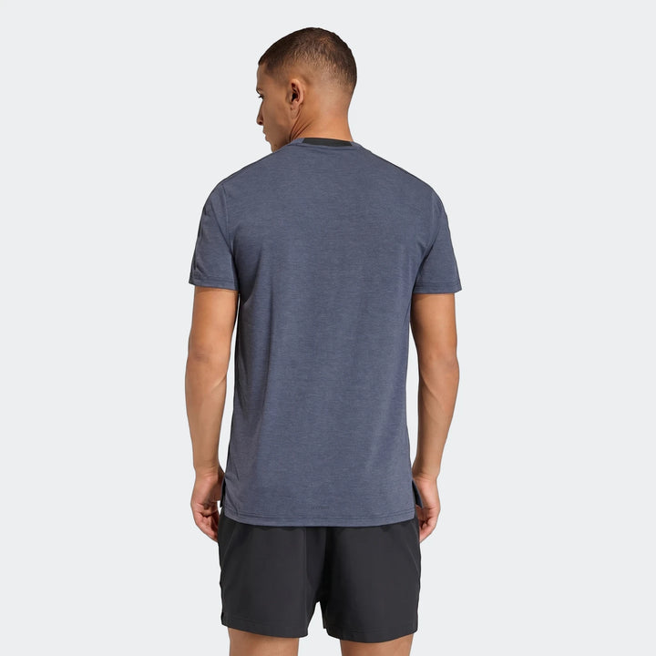 Blue D4T T-shirt on a male model from behind, paired with black athletic shorts, showcasing the shirt's fit.