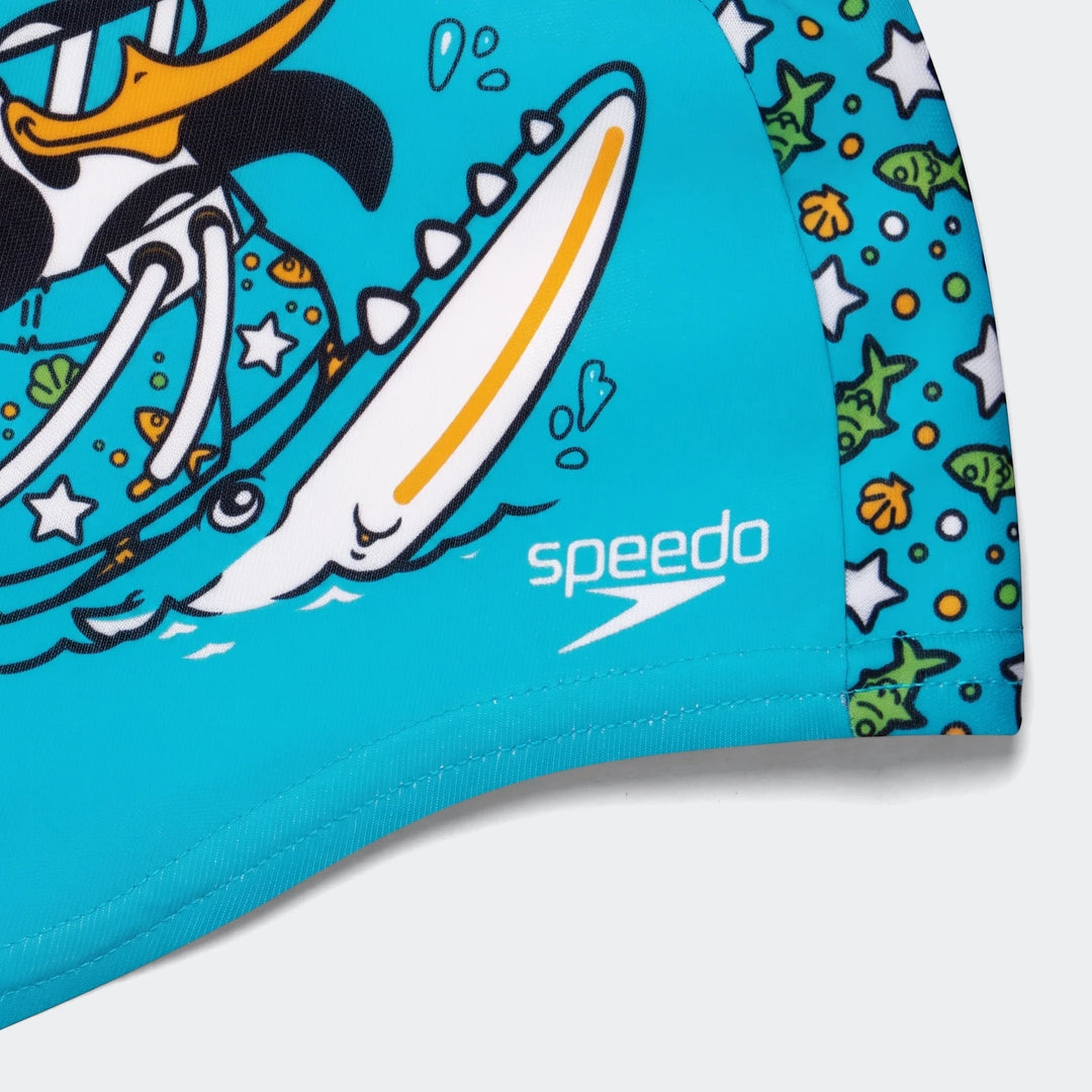 Blue Speedo printed polyester swim cap with a vibrant cartoon duck surfing design and marine life patterns.