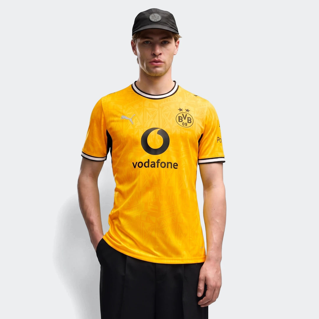 Borussia Dortmund 26/27 Home Jersey for men, featuring a vibrant yellow color and short sleeves, modeled with a black cap