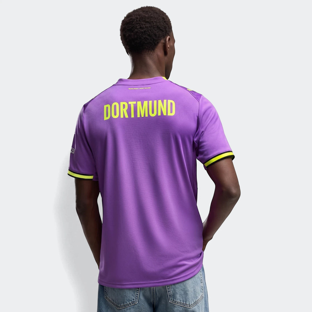 Purple Borussia Dortmund 26/27 Third Jersey for men, featuring yellow 'DORTMUND' text on the back, worn by a model in a back