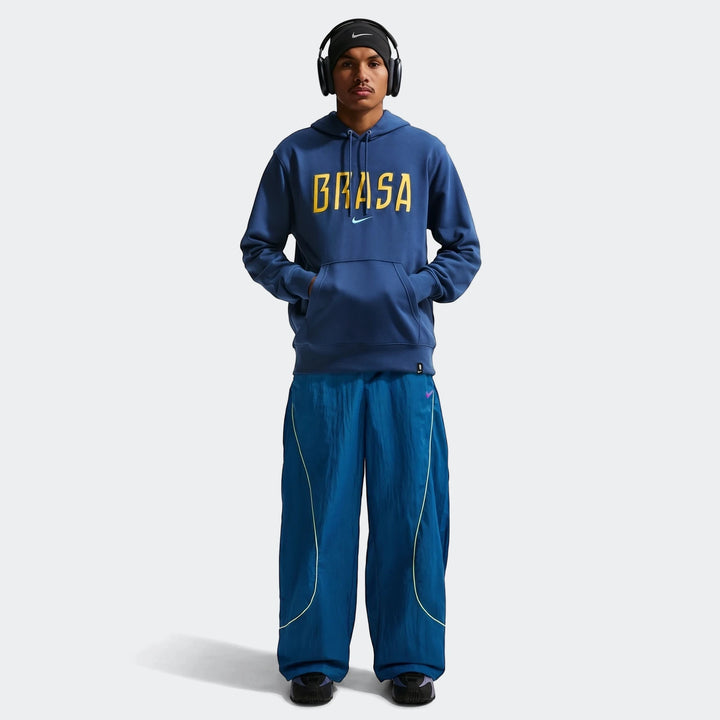 Brazil Club Blue Men's Nike Soccer French Terry Pullover Hoodie worn by a male model. Full body shot featuring blue track