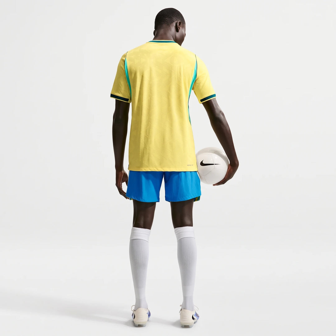 Brazil National Team 2026 Match Home Men's Nike Aero-Fit Soccer Jersey in yellow and blue, seen from the back, holding a