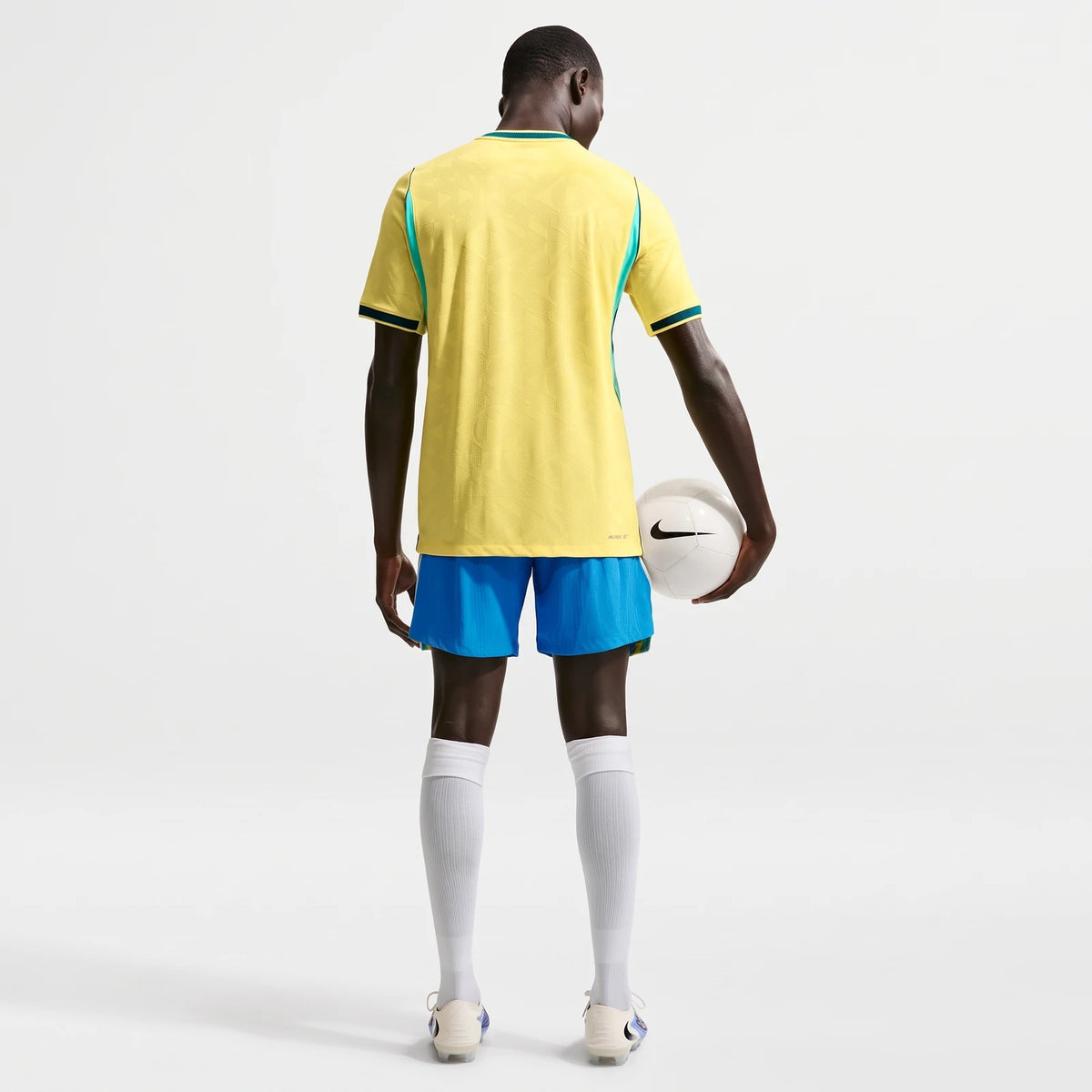 Brazil National Team 2026 Match Home Men's Nike Aero-Fit Soccer Jersey in yellow and blue, seen from the back, holding a