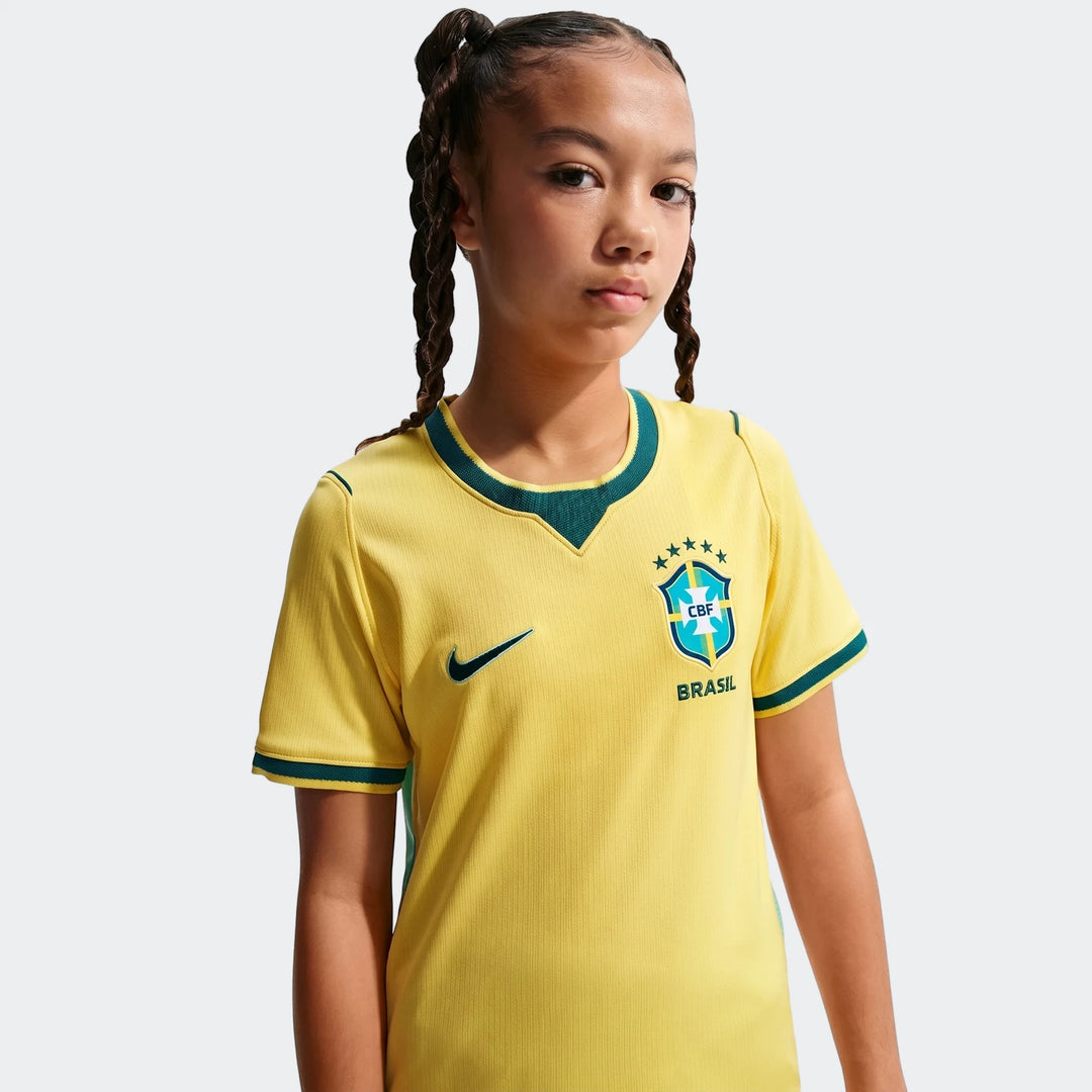 Brazil National Team 2026 Stadium Home Yellow Big Kids' Nike Dri-Fit Soccer Jersey worn by a young girl, front view.