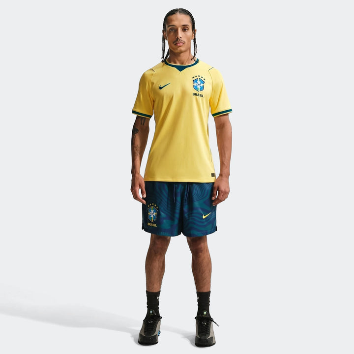 Full body shot of a male model wearing the yellow Brazil National Team 2026 Stadium Home Nike Dri-Fit soccer jersey and
