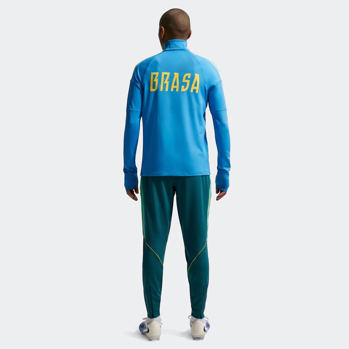 Men's Brazil Strike Nike Dri-Fit soccer knit pants in green with a blue long-sleeve top, viewed from the back.