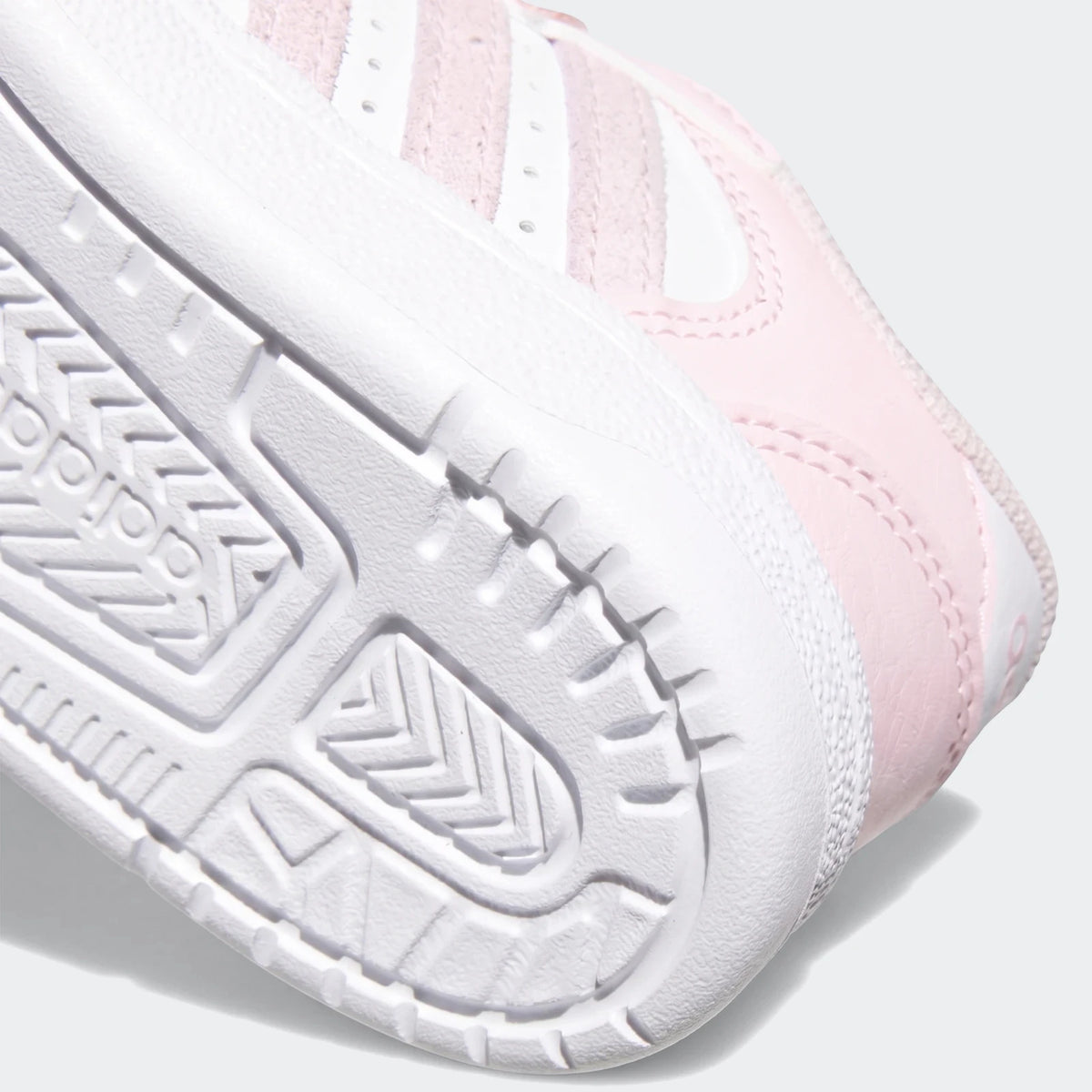 Close-up view of pink and white Break Start Kids Shoes, showing the textured white sole with partial branding and the side