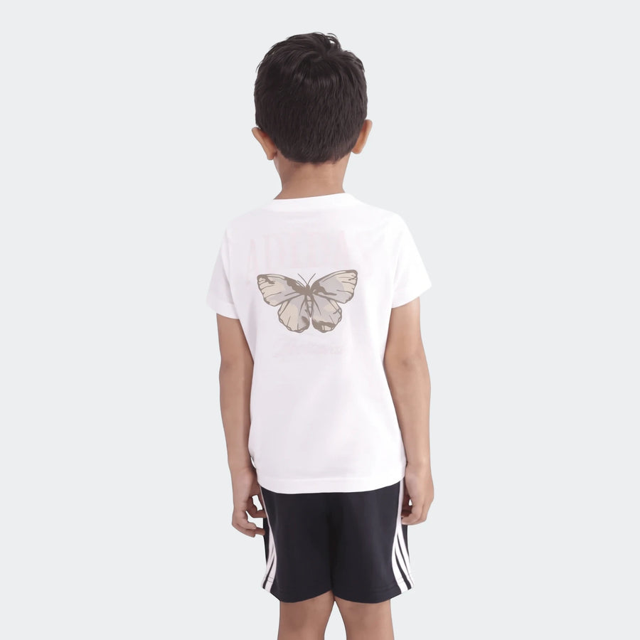 Young boy wearing a white Camo Graphic Tee with a butterfly print on the back, paired with dark shorts.
