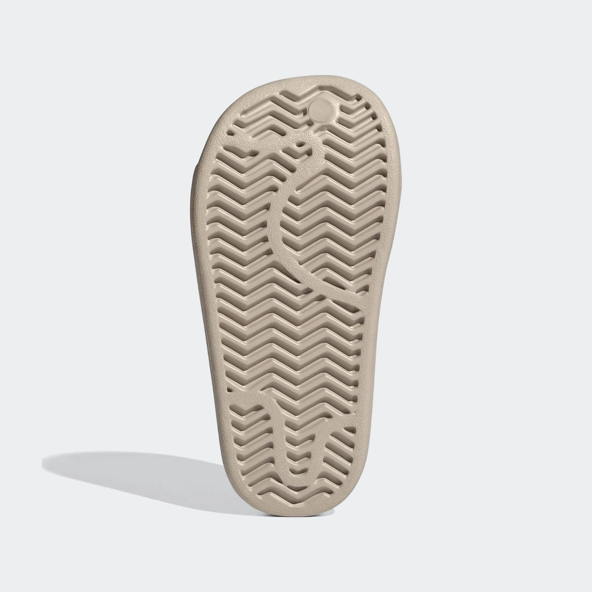 Bottom view of a beige Campus 00S Foam Slide, showcasing its textured grip sole pattern for traction.