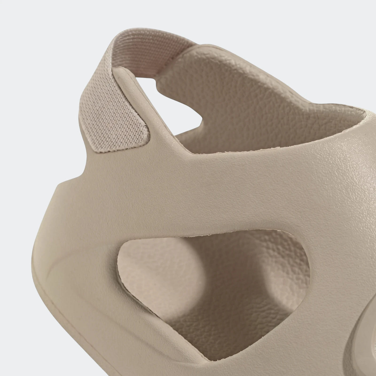 Close-up of a single light beige Campus 00S Foam Slide sandal, featuring a textured surface and side cutouts.